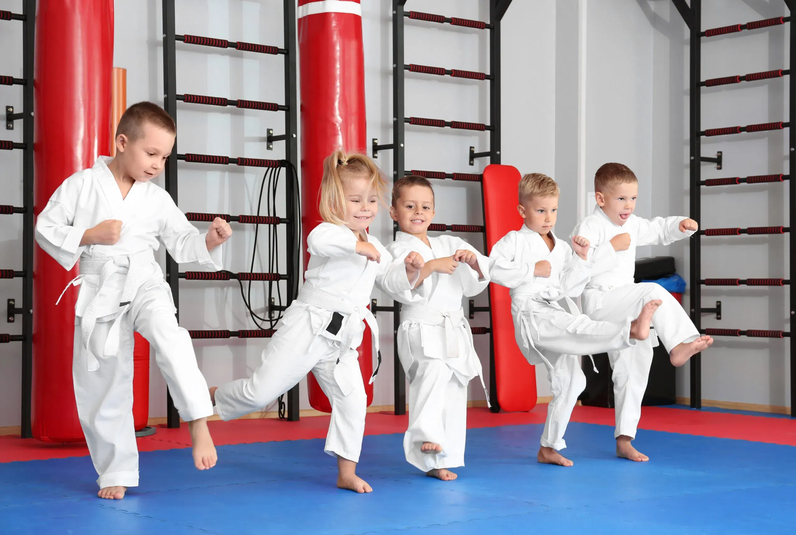 Little children practicing karate in dojo